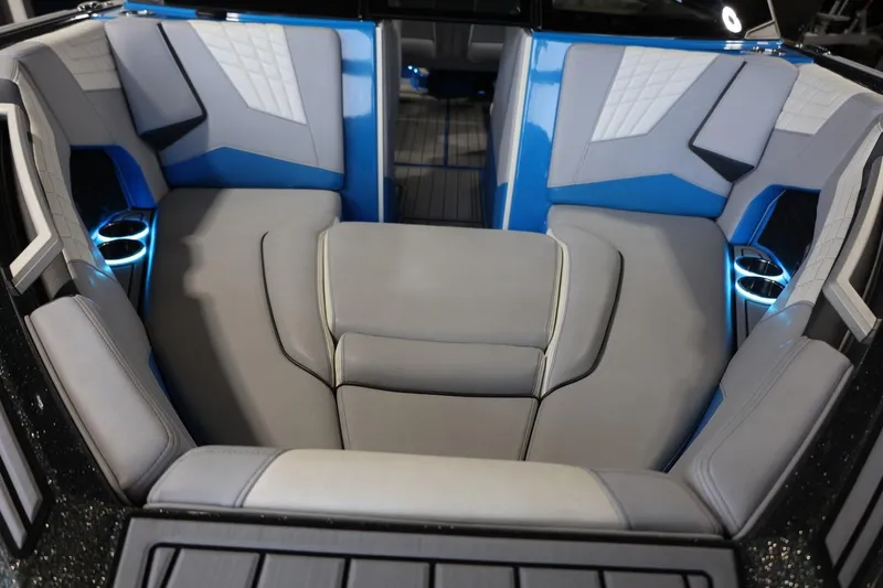 Slide: The Image of Luxurious interior of 2022 Nautique Super Air Nautique S23 boat with blue accents. - 53