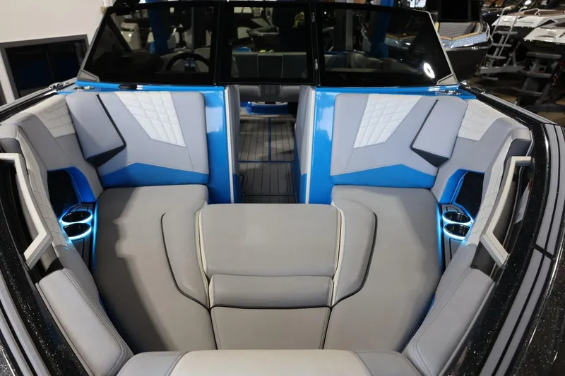 Slide: The Image of 2022 Nautique Super Air Nautique S23 interior with blue and gray seating. - 54