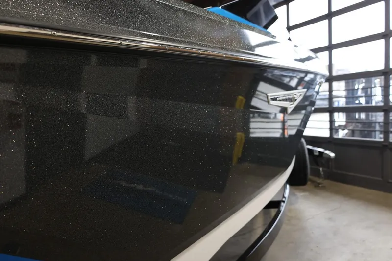 Slide: The Image of 2022 Nautique Super Air Nautique S23 boat in a garage, showcasing sleek design. - 61