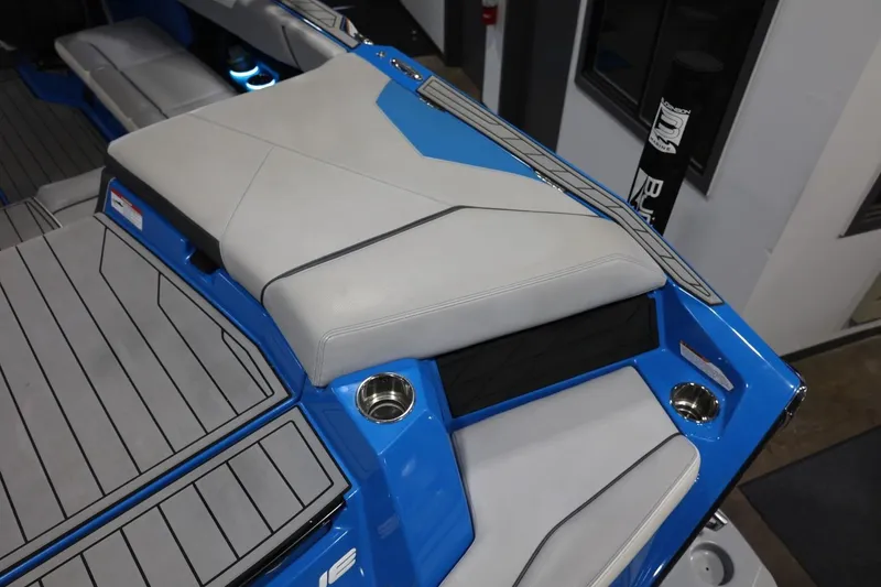 Slide: The Image of 2022 Nautique Super Air Nautique S23 boat interior with blue and gray seating. - 67