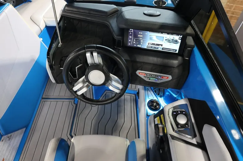 Slide: The Image of 2022 Nautique Super Air Nautique S23 dashboard with steering wheel and touchscreen display. - 71