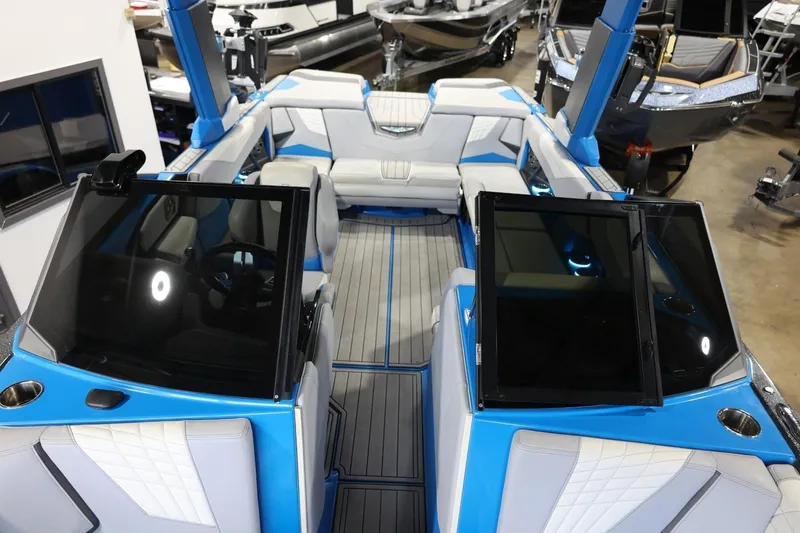 Slide: The Image of 2022 Nautique Super Air Nautique S23 boat interior with blue and white seating. - 75
