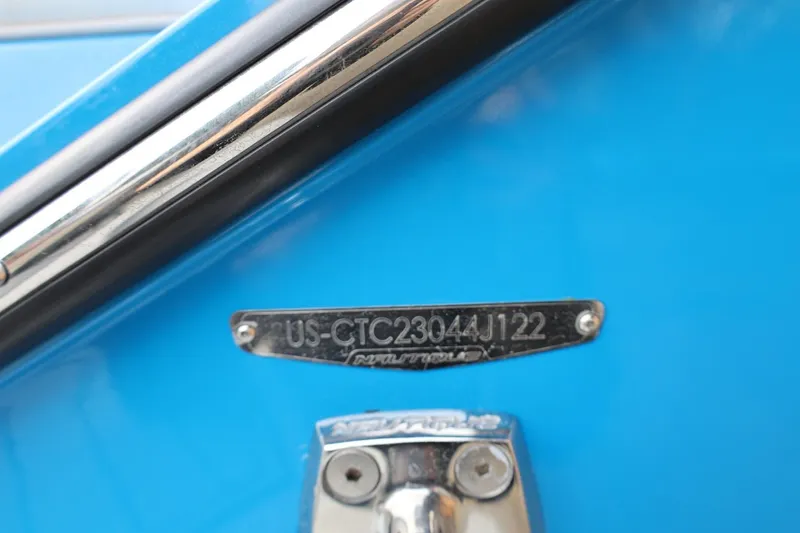 Slide: The Image of 2022 Nautique Super Air Nautique S23 boat interior with blue and gray seating and deck. - 8