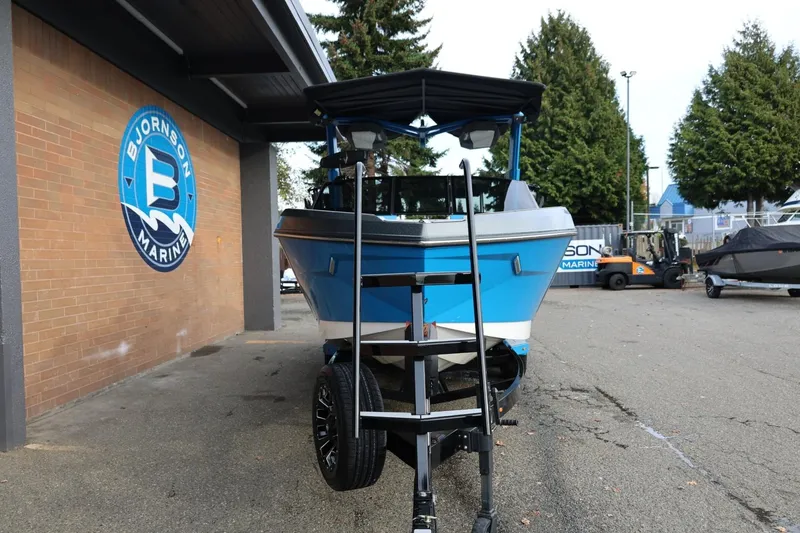 Slide: The Image of 2022 Nautique Super Air Nautique S23 boat interior with blue and gray seating. - 9