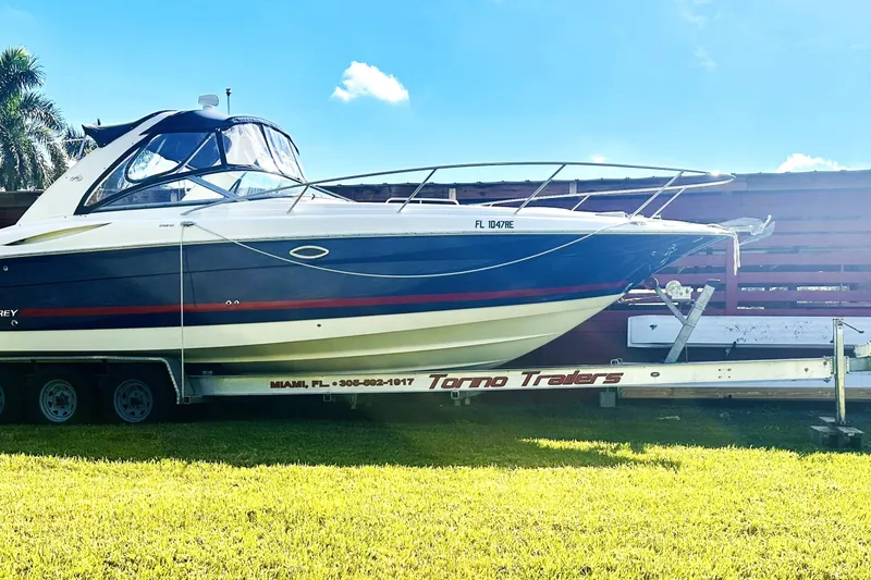 Slide: The Image of Engine compartment of a 2006 Monterey 298SC Super Sport boat, featuring dual red engines. - 13