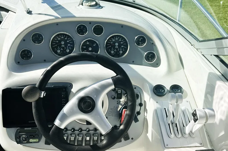 Slide: The Image of White leather seat on 2006 Monterey 298SC Super Sport boat under blue sky. - 6