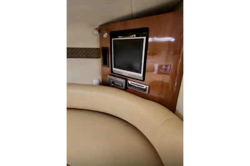 Slide: The Image of Interior of 2006 Monterey 298SC Super Sport boat with beige seating and nautical decor. - 9
