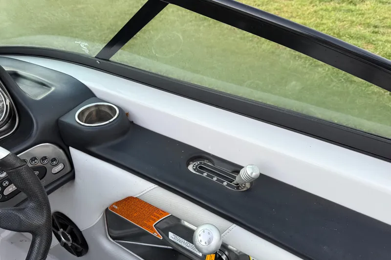 Slide: The Image of Interior of 2010 Nautique Super Air Nautique 230 boat, featuring dashboard and controls. - 10