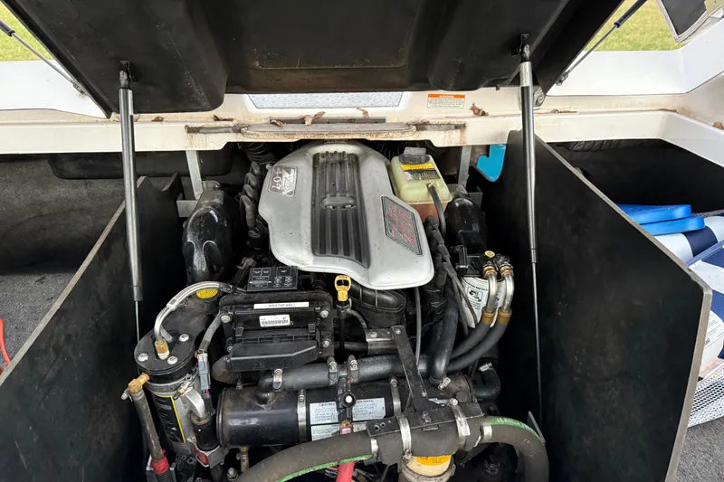 Slide: The Image of Engine compartment of 2010 Nautique Super Air Nautique 230 boat, showcasing detailed components. - 11