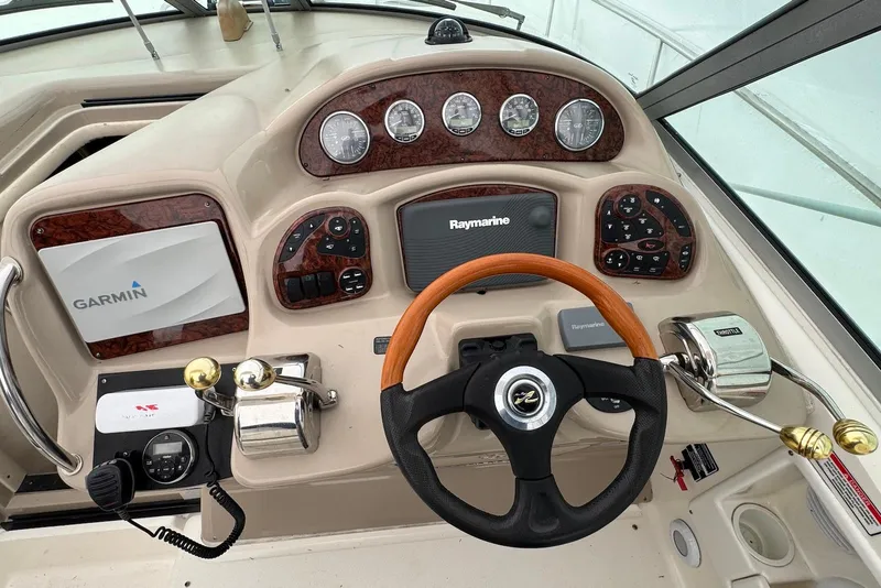 Slide: The Image of Cockpit of 2004 Sea Ray 320 Sundancer with Garmin and Raymarine navigation systems. - 10
