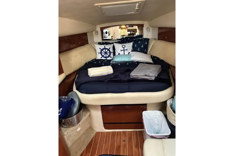 Slide: The Image of Luxurious cabin interior of 2004 Sea Ray 320 Sundancer with nautical-themed bedding. - 11