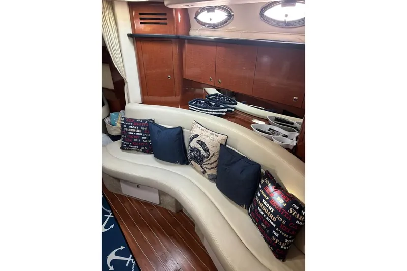 Slide: The Image of Luxurious interior of 2004 Sea Ray 320 Sundancer with plush seating and nautical-themed decor. - 12