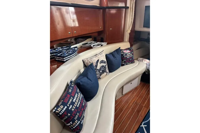 Slide: The Image of Luxurious interior of 2004 Sea Ray 320 Sundancer with plush seating and decorative pillows. - 13