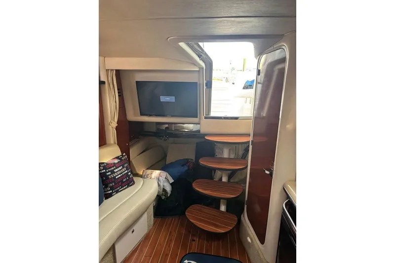 Slide: The Image of Interior of 2004 Sea Ray 320 Sundancer with wooden steps and a TV. - 14