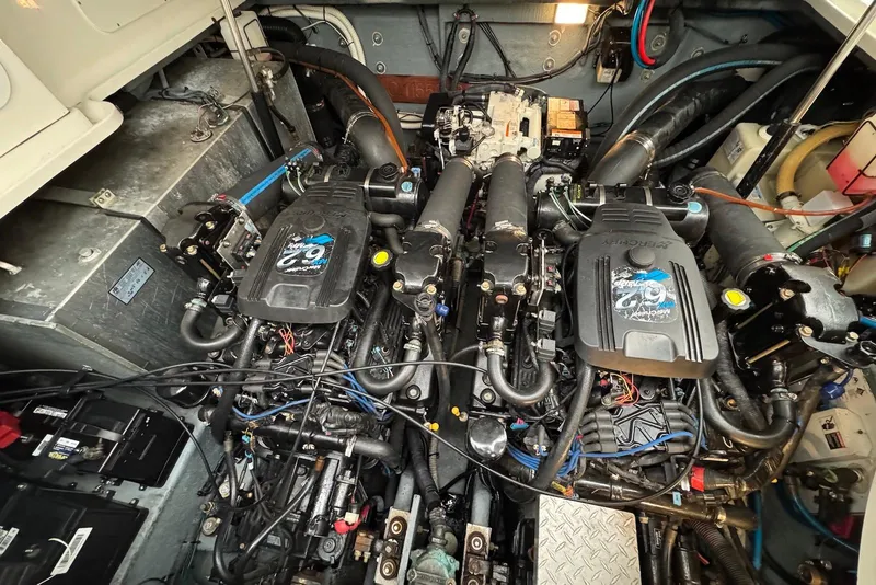 Slide: The Image of Engine compartment of a 2004 Sea Ray 320 Sundancer boat, showcasing dual engines. - 17