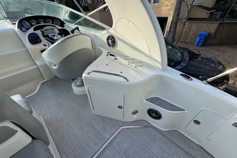 Slide: The Image of 2004 Sea Ray 280 Sundancer cockpit with steering wheel, seating, and control panel. - 6