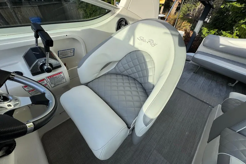 Slide: The Image of 2004 Sea Ray 280 Sundancer helm with luxurious seating and control panel. - 7