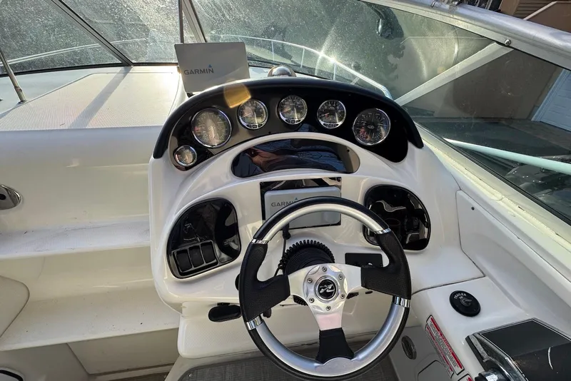 Slide: The Image of Cockpit of 2004 Sea Ray 280 Sundancer with Garmin navigation system and steering wheel. - 8