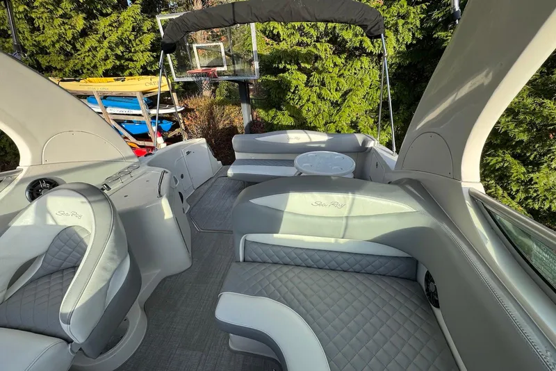 Slide: The Image of 2004 Sea Ray 280 Sundancer boat interior with gray seating and canopy. - 9