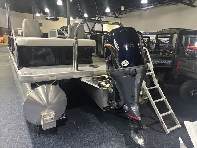 Slide: The Image of 2026 Godfrey Pontoons Xperience 2086 with outboard motor in a showroom. - 11