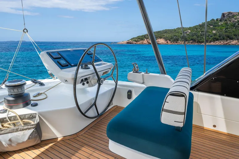 Slide: The Image of Manufacturer Provided Image: Helm of Lagoon Eighty 2 yacht, 2026 model, overlooking turquoise sea and lush island. - 3