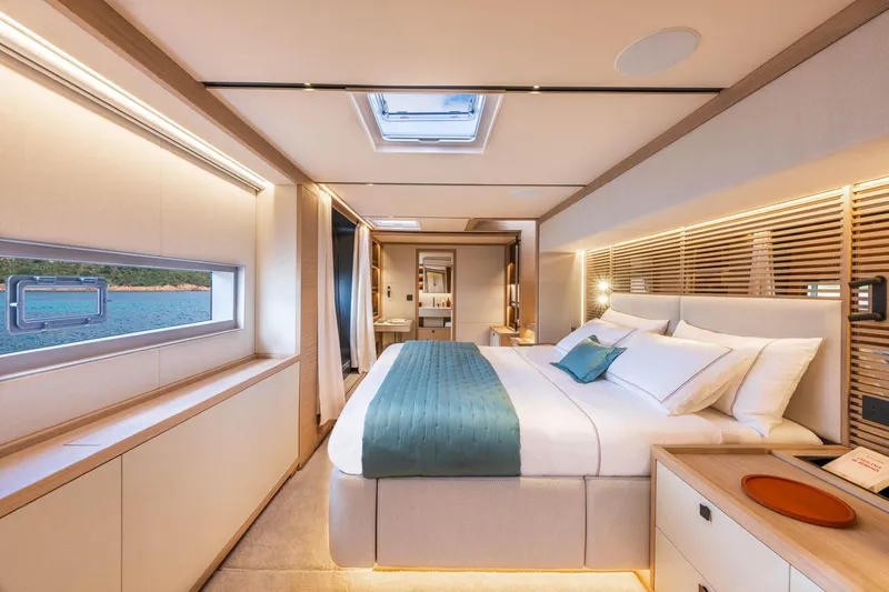 Slide: The Image of Manufacturer Provided Image: Luxurious bedroom interior of 2026 Lagoon Eighty 2 yacht with ocean view. - 8