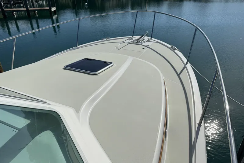 Slide: The Image of 2020 Back Cove 34O boat deck with railing, docked on calm water. - 11