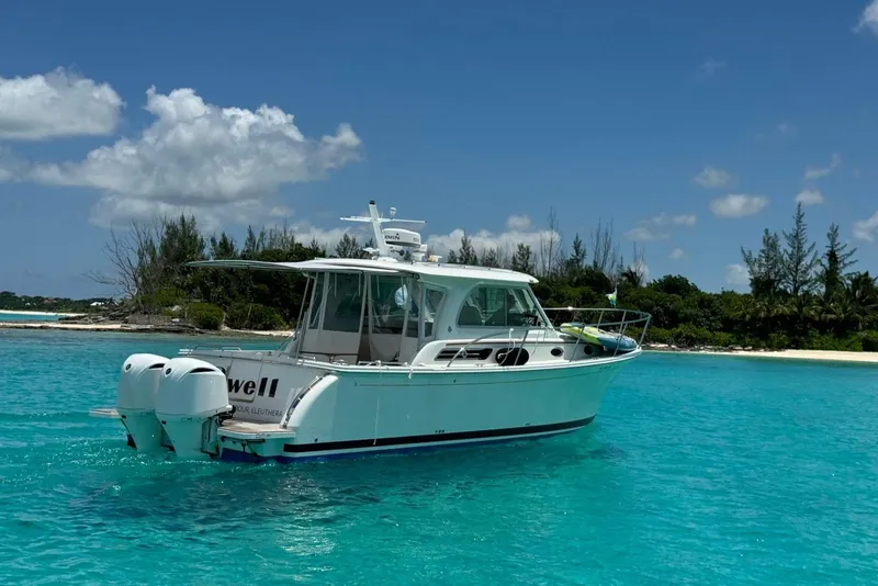 Slide: The Image of 2020 Back Cove 34O boat on turquoise water near tropical island. - 15