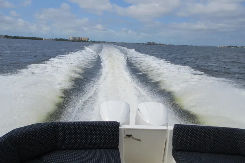 Slide: The Image of Wake trail behind 2020 Back Cove 34O boat on open water under cloudy sky. - 18