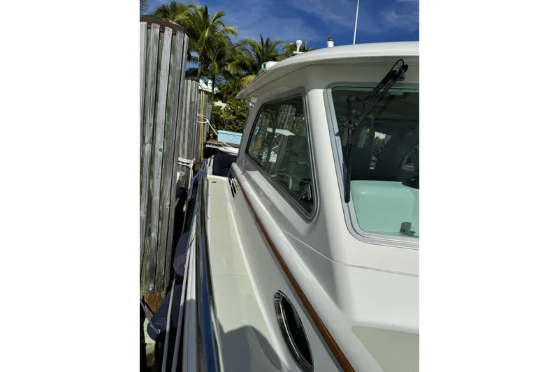 Slide: The Image of 2020 Back Cove 34O yacht docked, showcasing sleek design and side view. - 19