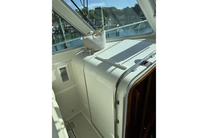 Slide: The Image of Interior view of 2020 Back Cove 34O boat with sunlight and window reflections. - 29