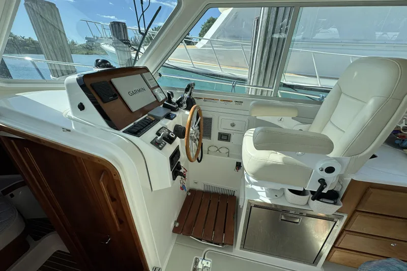 Slide: The Image of 2020 Back Cove 34O helm with Garmin navigation, luxurious seating, and modern controls. - 31