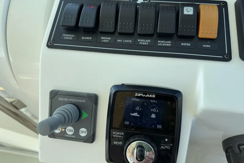 Slide: The Image of Control panel of a 2020 Back Cove 34O boat with switches and Zipwake system. - 35