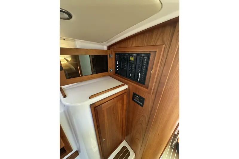 Slide: The Image of 2020 Back Cove 34O interior with wooden cabinetry and control panel. - 37