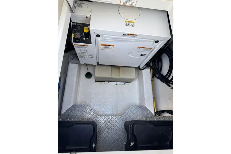 Slide: The Image of Engine compartment of a 2020 Back Cove 34O boat, featuring a generator and wiring. - 50