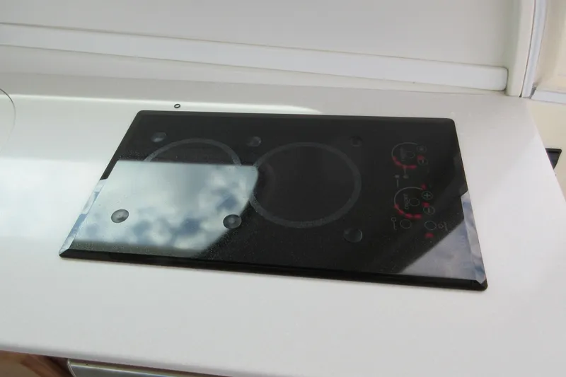 Slide: The Image of 2020 Back Cove 34O yacht featuring a sleek glass cooktop in the galley. - 54