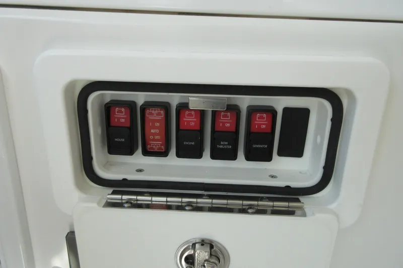 Slide: The Image of Control panel of a 2020 Back Cove 34O boat with labeled switches. - 61