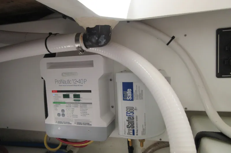 Slide: The Image of Electrical components in a 2020 Back Cove 34O boat, featuring ProNautic 12-40P charger. - 62