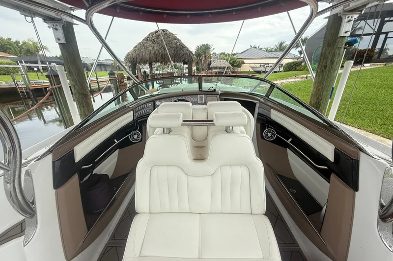Slide: The Image of Interior of a 2007 Cobalt 343 boat with white seating and sleek dashboard design. - 7