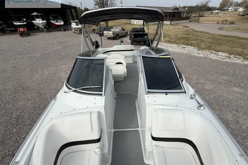Slide: The Image of 2007 Formula 260 Bowrider boat with spacious seating and sleek design in a marina setting. - 14
