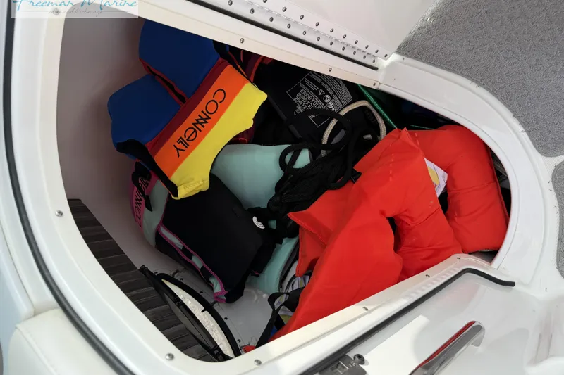 Slide: The Image of Storage compartment in a 2007 Formula 260 Bowrider with life jackets and boating gear. - 22