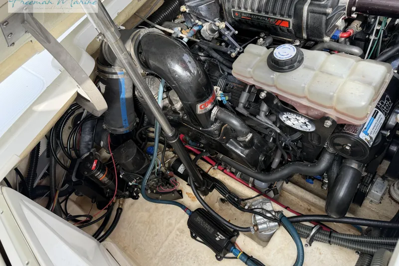 Slide: The Image of Engine compartment of a 2007 Formula 260 Bowrider boat, showcasing detailed mechanical components. - 25