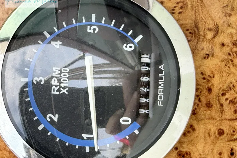 Slide: The Image of Tachometer of 2007 Formula 260 Bowrider, displaying RPM x1000, with wood grain background. - 30