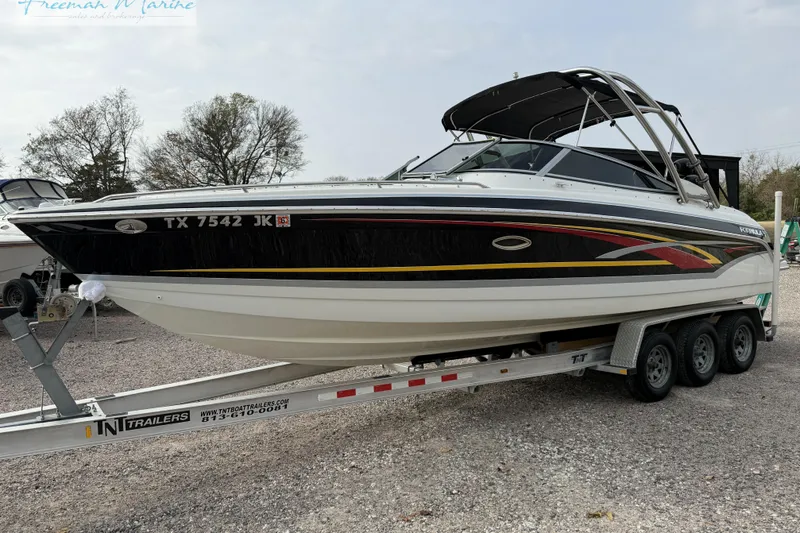 Slide: The Image of 2007 Formula 260 Bowrider boat on trailer, side view, outdoors. - 4
