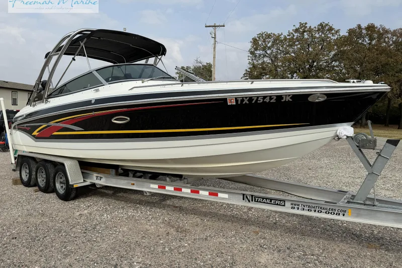 Slide: The Image of 2007 Formula 260 Bowrider boat on trailer, black and white design, parked outdoors. - 6