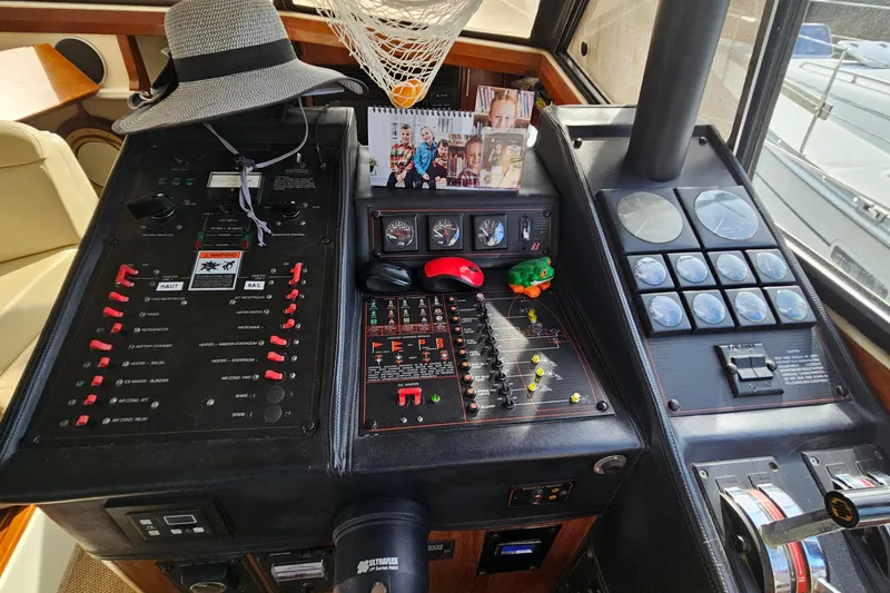 Slide: The Image of Control panel of a 1991 Bayliner 3888 Motoryacht with gauges and personal items. - 15