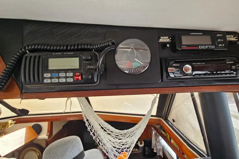 Slide: The Image of Interior of 1991 Bayliner 3888 Motoryacht with radio, depth gauge, and rudder indicator. - 16