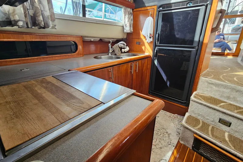 Slide: The Image of Interior of 1991 Bayliner 3888 Motoryacht kitchen with wood cabinetry and appliances. - 17