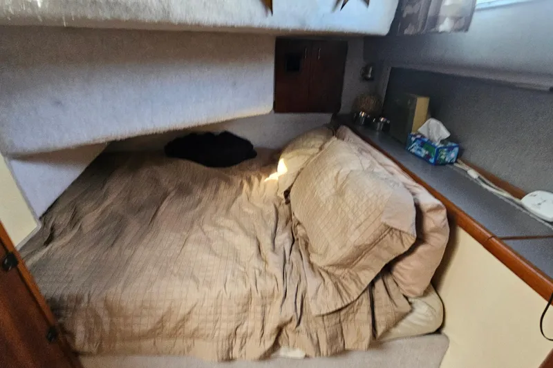 Slide: The Image of Cozy cabin interior of 1991 Bayliner 3888 Motoryacht with bed and storage. - 21