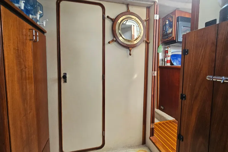 Slide: The Image of Interior of 1991 Bayliner 3888 Motoryacht with wooden cabinetry and nautical decor. - 22